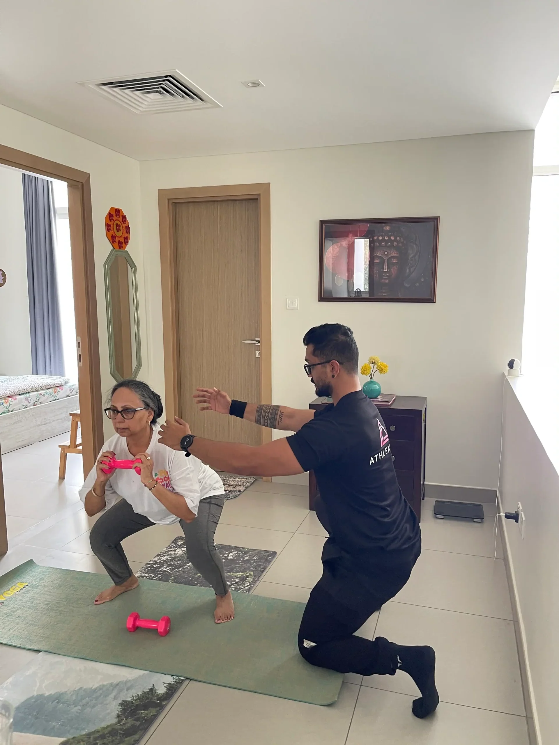 Senior personal trainer Dubai conducting an at-home training session with an elderly client
